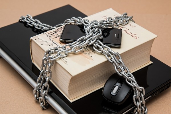 laptop-book-and-mobile-phone-in-chain